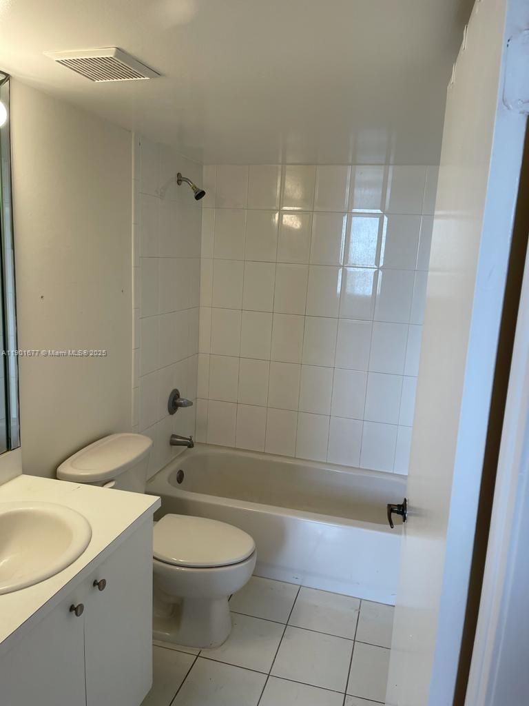 8251 Northwest 8th Street, Unit 414 Miami, FL 33126 - Photo 12 of 25 a bathroom with a sink a toilet and shower