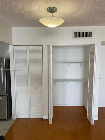 a bathroom with a granite countertop toilet and a shower
