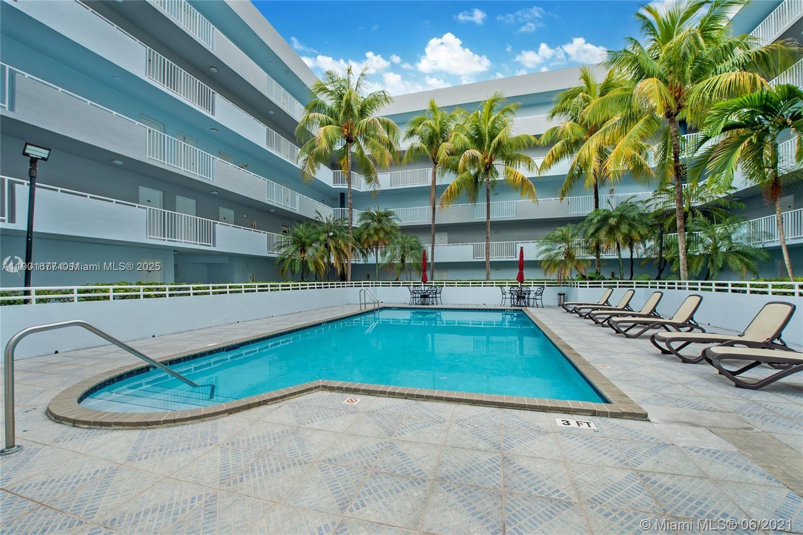 8251 Northwest 8th Street, Unit 414 Miami, FL 33126 - Photo 2 of 25 a view of a swimming pool with a lounge chair