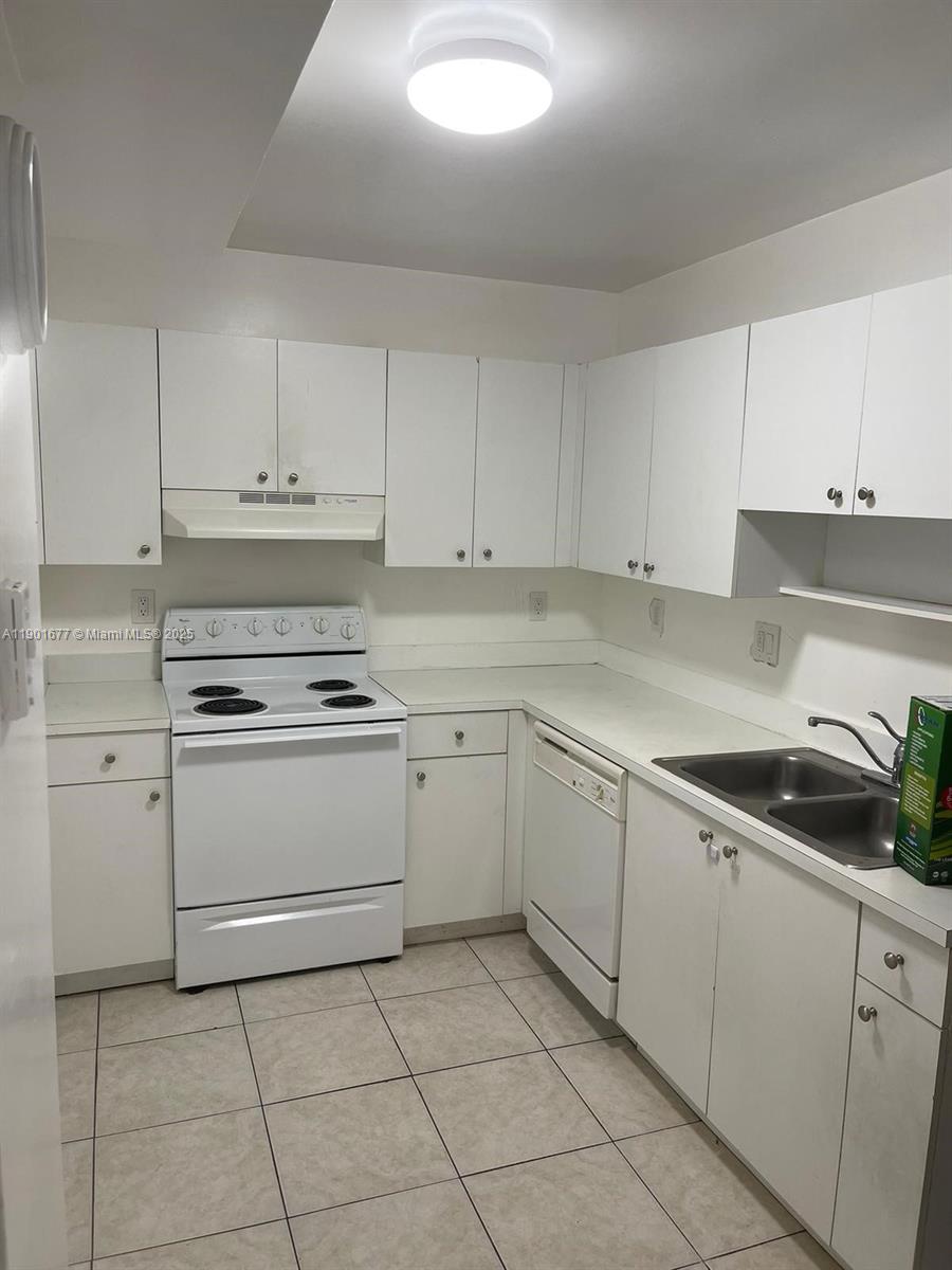 8251 Northwest 8th Street, Unit 414 Miami, FL 33126 - Photo 25 of 25 a kitchen with cabinets appliances and a sink