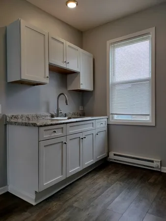 a kitchen with granite countertop cabinets stainless steel appliances and a sink
