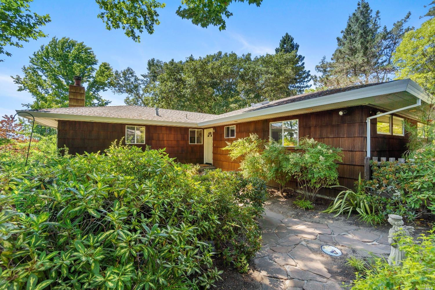 a view of a house with balcony and garden