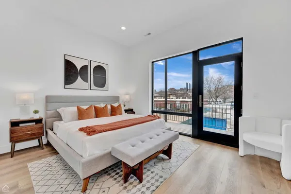 a bed room with a bed and a large window