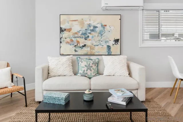 a living room with furniture a rug and a table