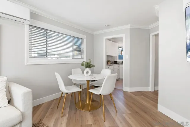 a dining room with furniture and wooden floor