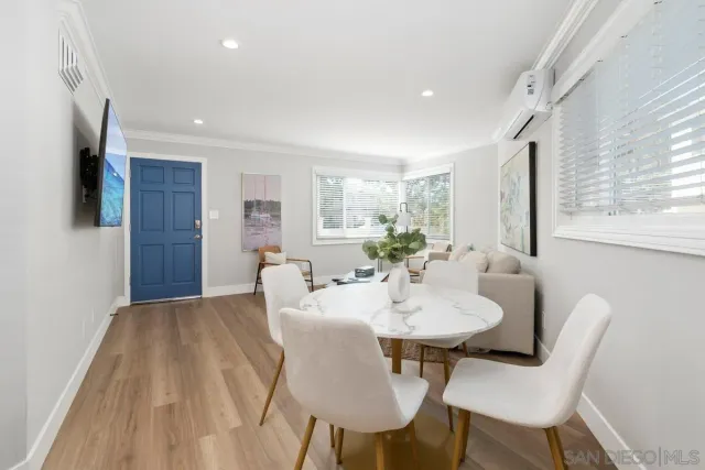 a view of a dining room with furniture and a window