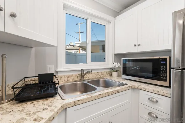 a kitchen with a sink stove and cabinets