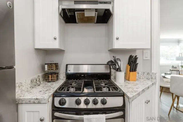 a white stove top oven sitting inside of a kitchen
