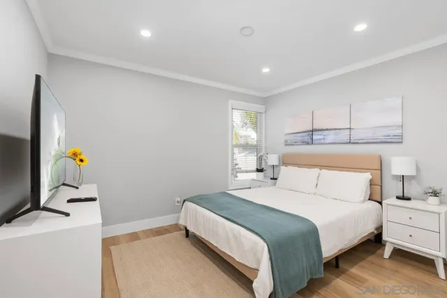 a bedroom with a bed and a dresser