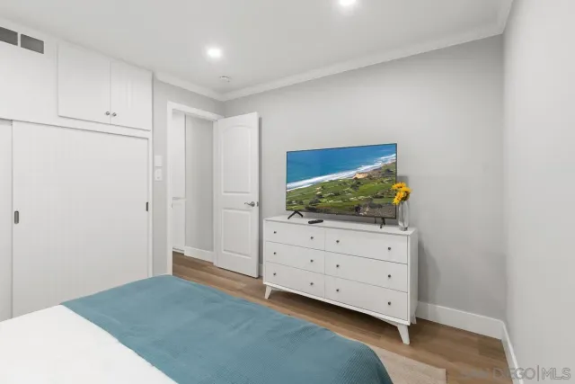 a bedroom with a bed and cabinet