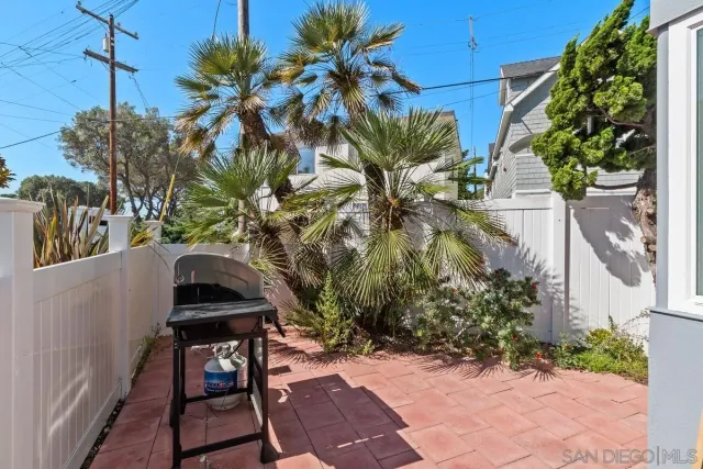 a view of a backyard with plants and a patio