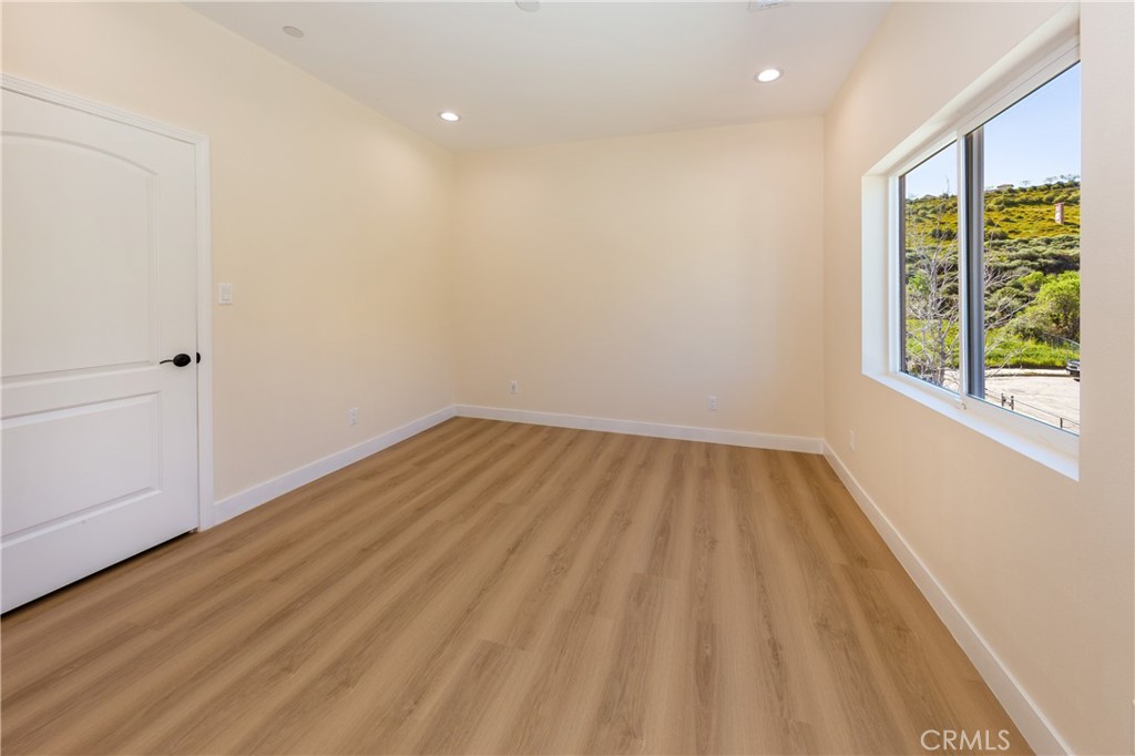 26210 Larkhaven Place Newhall, CA 91321 - Photo 23 of 29 wooden floor in an empty room with a window