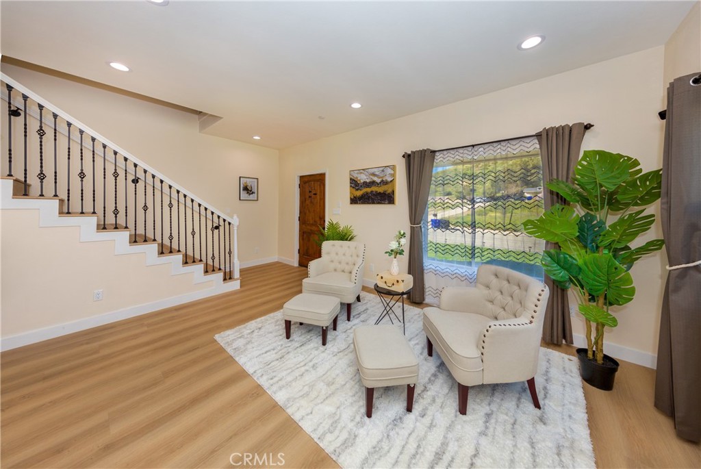 26210 Larkhaven Place Newhall, CA 91321 - Photo 5 of 29 a living room with furniture and a potted plant