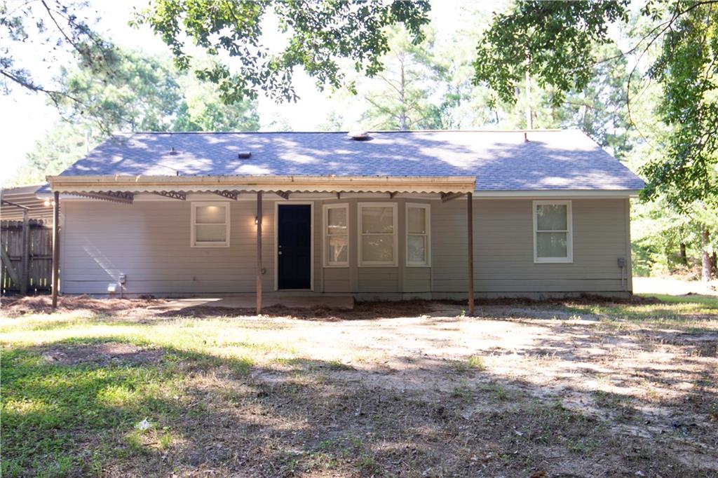 95 Lee Road Salem, AL 36874 - Photo 10 of 13 Rear exterior with a covered patio, light-colored siding, and a dark entry door