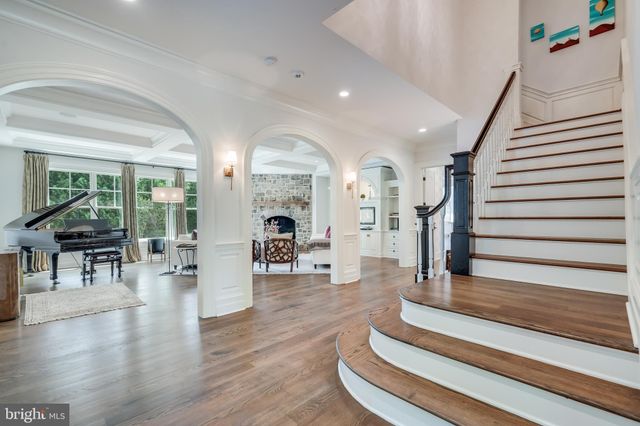 a kitchen with a stove a refrigerator and a dining table with wooden floor