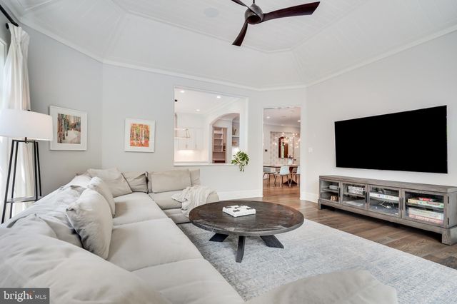 a room with table chairs and wooden floor