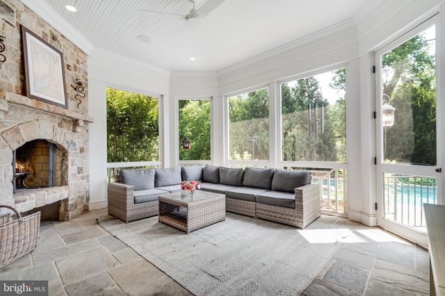 a spacious bedroom with a bed dresser and a chandelier