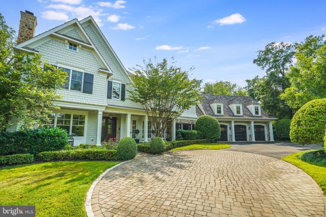 a living room with furniture a fireplace and a large window
