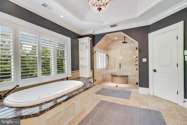 a backyard of a house with table and chairs plants and large trees