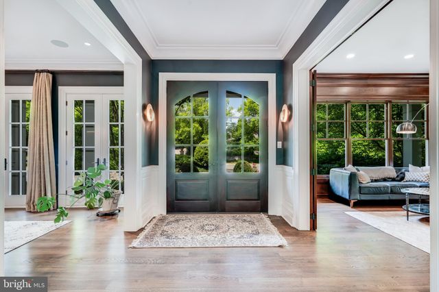 a living room with furniture a fireplace and a large window