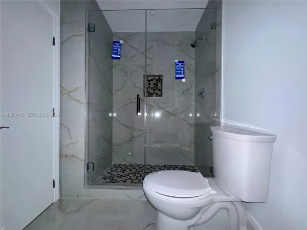 a bathroom with a toilet sink vanity and mirror