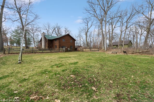 a big house with a big yard and large trees