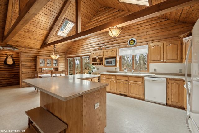 a kitchen with sink cabinets and window