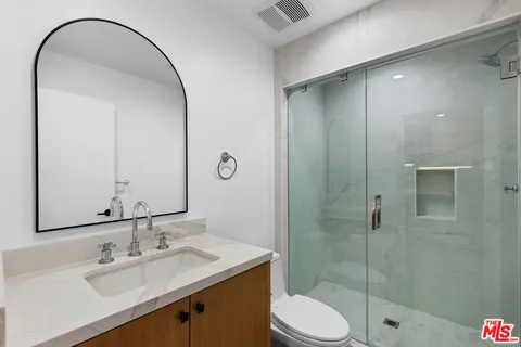 a bathroom with a sink toilet and shower