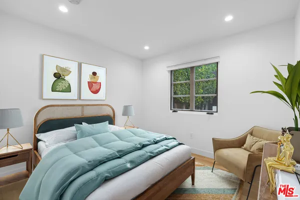 a bedroom with a bed and a couch