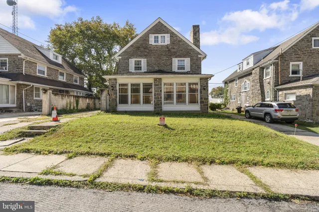 a view of a big house with a yard in front of it