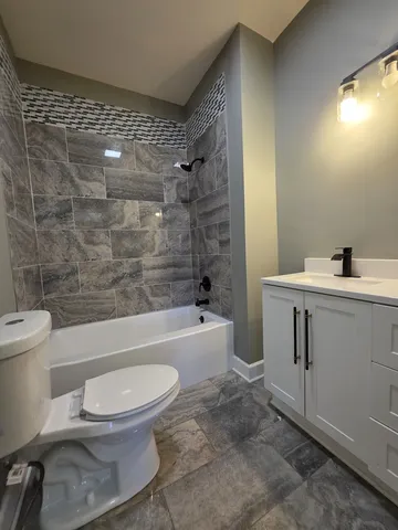 a bathroom with a toilet a sink and bathtub