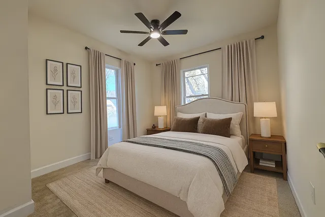 a bedroom with a large bed and a chandelier