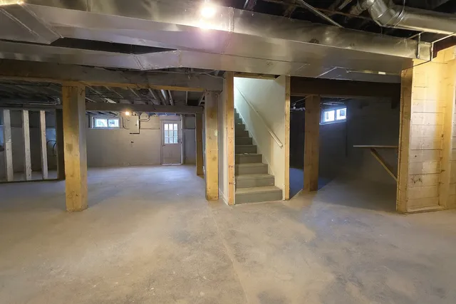 a view of a hallway with wooden cabinets