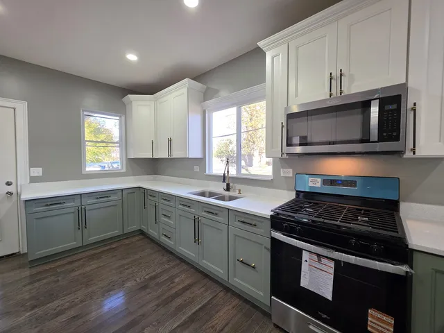 a kitchen with a sink stove and microwave