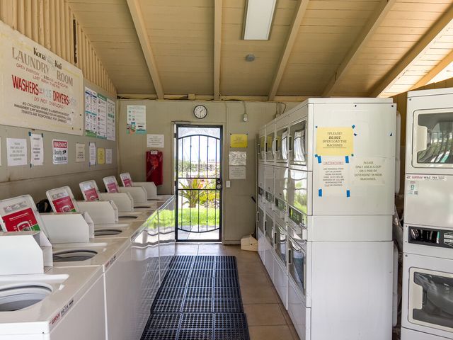 a hallway with a couch and a dining table with chairs