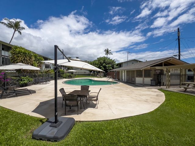 a view of a house with backyard sitting area and garden