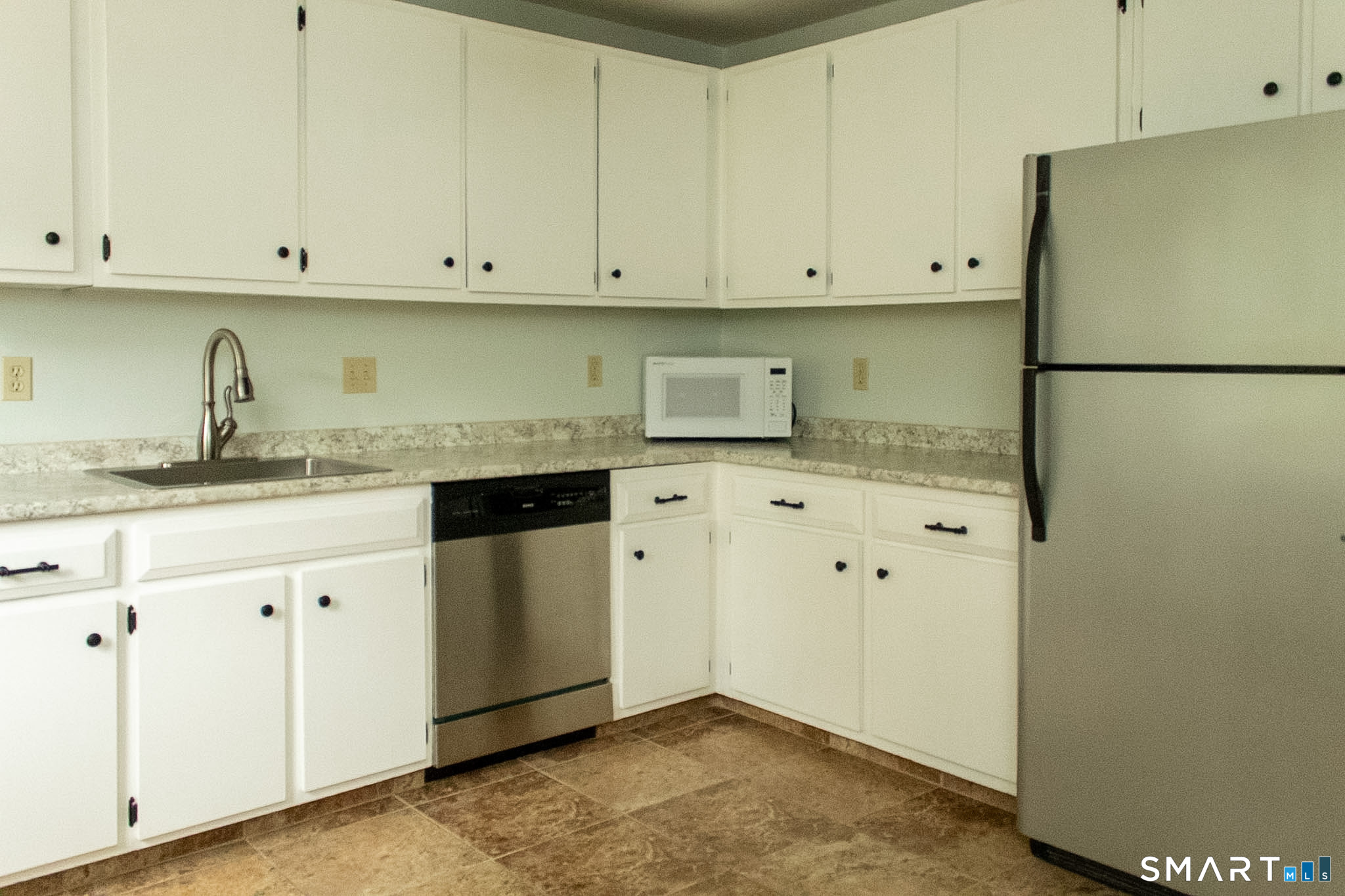 10 Georgetown Drive, Unit J Enfield, CT 06082 - Photo 3 of 15 a kitchen with granite countertop white cabinets and stainless steel appliances
