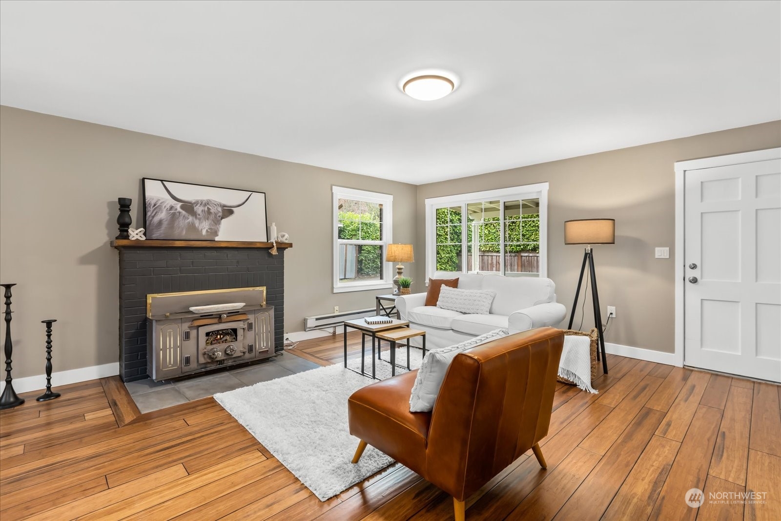 24231 23rd Avenue Southeast Bothell, WA 98021 - Photo 5 of 40 a living room with furniture a fireplace and a wooden floor