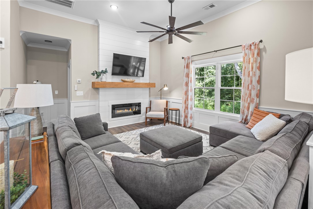 322 Thompson Street Pendleton, SC 29670 - Photo 7 of 38 High ceilings and a modern fireplace elevate this welcoming living space.