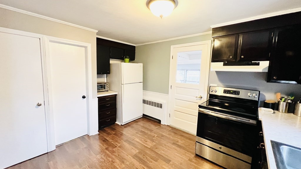94 Witheridge Street Feeding Hills, MA 01030 - Photo 21 of 24 a kitchen with a refrigerator and a stove top oven