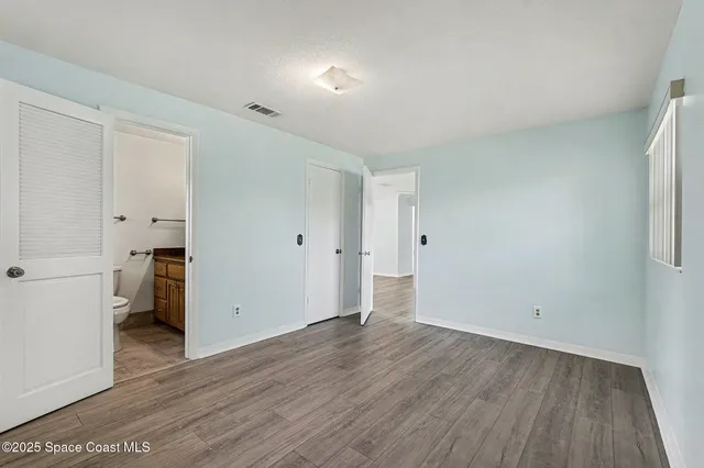 a view of a room with wooden floor