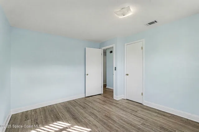 a view of room with wooden floor and window