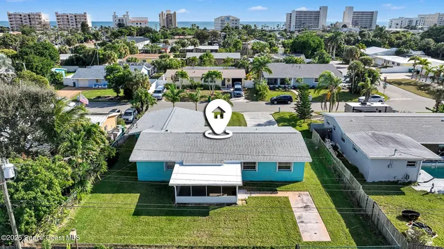 a aerial view of a house with garden space and street view