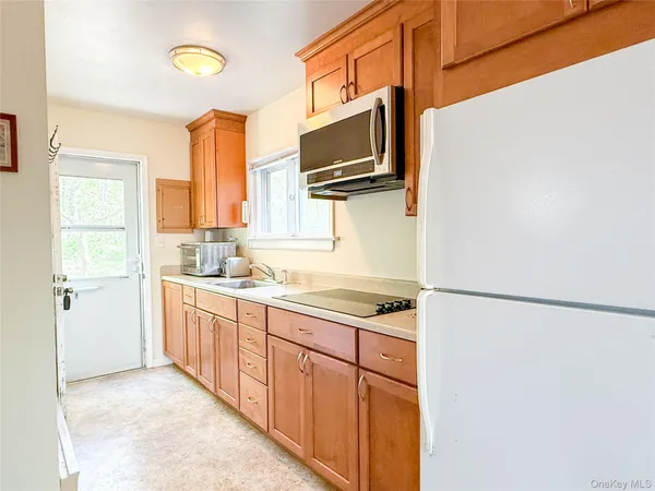 a kitchen with stainless steel appliances a refrigerator sink and microwave