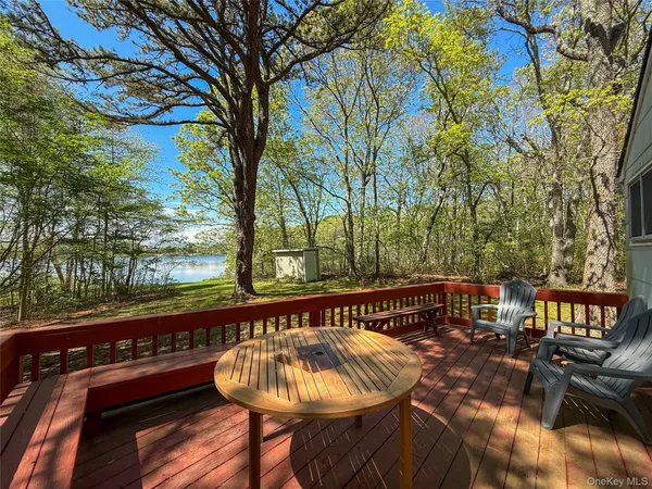 a view of balcony with wooden floor and outdoor seating