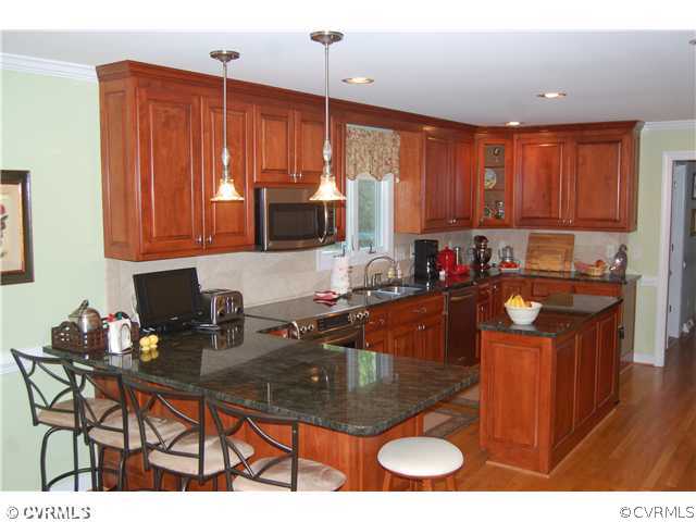 13620 Thorngate Road Midlothian, VA 23113 - Photo 4 of 12 a kitchen with a sink refrigerator and cabinets