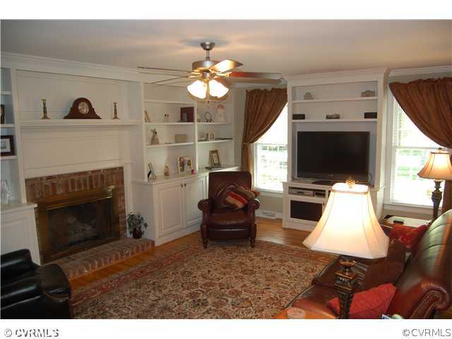 13620 Thorngate Road Midlothian, VA 23113 - Photo 7 of 12 a living room with furniture a flat screen tv and a fireplace