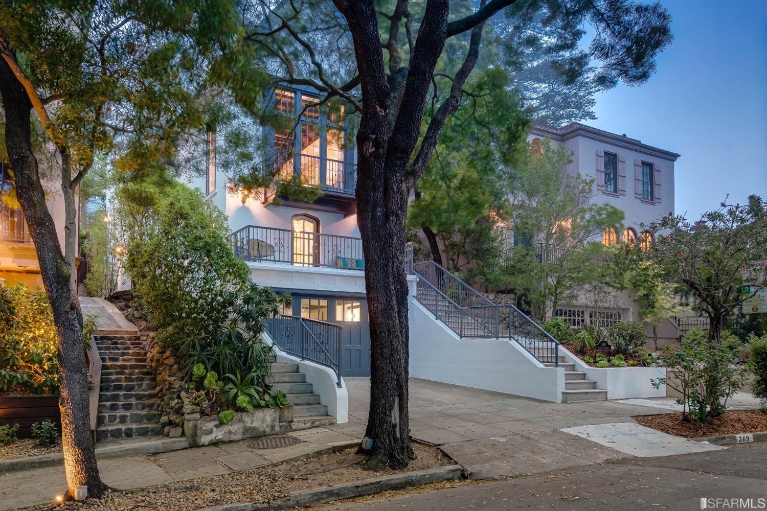 a view of a brick house with a tree