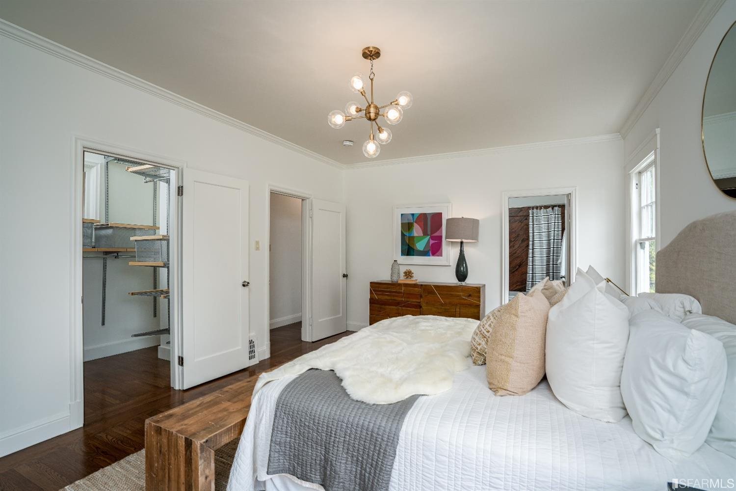 369 Pacheco Street San Francisco, CA 94116 - Photo 20 of 49 a bedroom with a bed and a chandelier