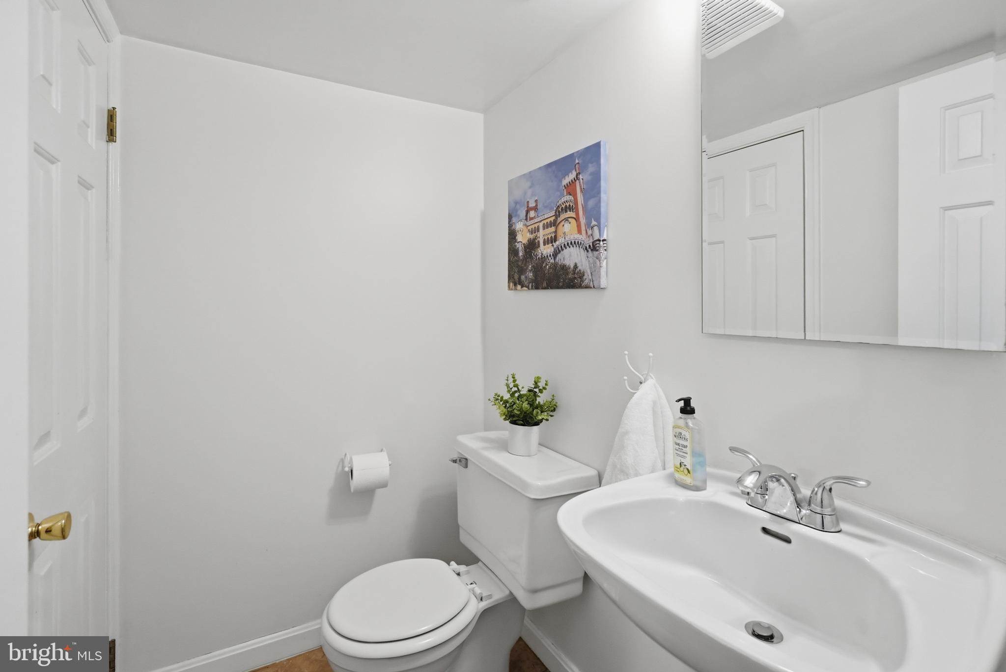 7006 Barnack Drive Springfield, VA 22152 - Photo 40 of 56 a bathroom with a sink mirror and toilet
